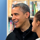 While shopping at a bookstore in Arlington, Va., Obama refers to a list of books stored on his BlackBerry.